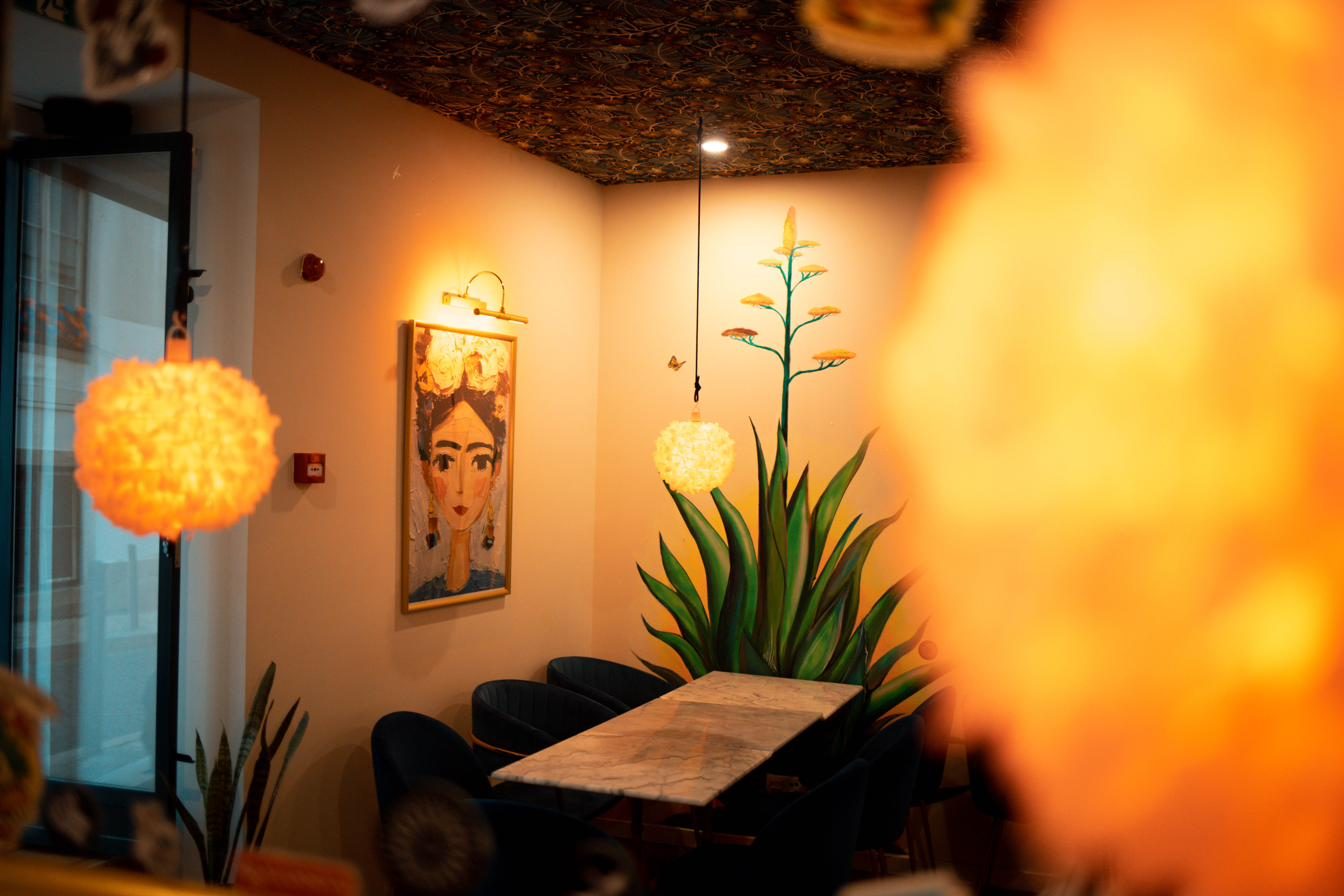 Seating area with agave mural at Agave Cocktail Lab