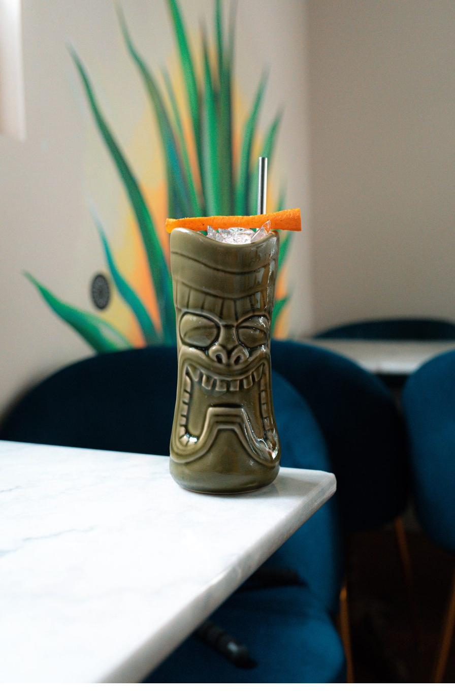 Tiki mug cocktail with orange peel garnish
